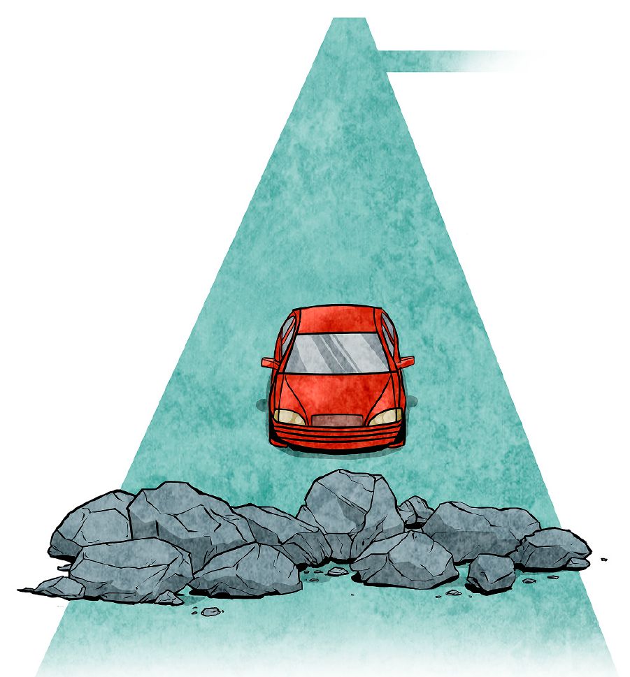 Auto sa blíži k hŕbe kamenia na ceste