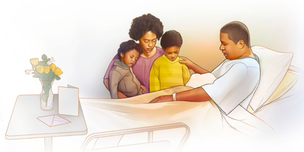 Baba kwenye kitanda cha hospitali anasali pamoja na familia yake