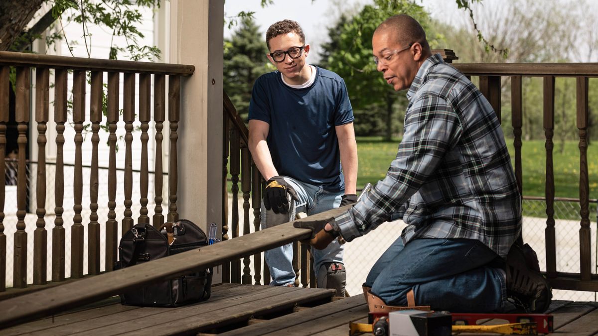 One young brother de learn how to do furniture from another brother.