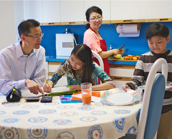 Parents helping their children at home